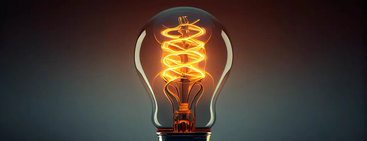 Glowing filament light bulb symbolizing innovation, creativity, and bright ideas on dark background.