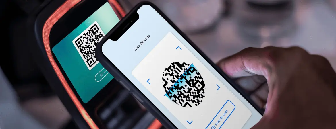 Scanning QR code on smartphone for digital payment.
